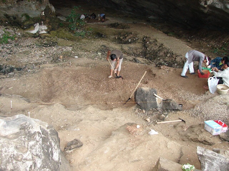 Archaeologists carefully uncovering ancient artifacts from Cai Beo Time in Halong